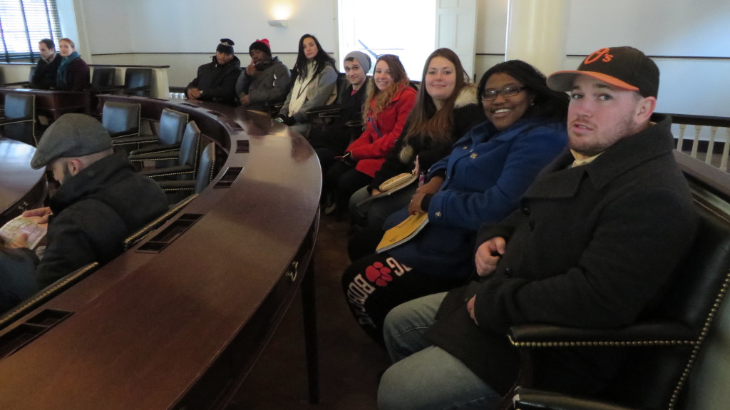 The group of students sit in Independence Hall (Dr. Sheri Whalen).