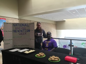 Jessica Warren, a member of Alpha Sigma Alpha, and Landos Wallace, a member of Pi Lambda Phi, working the bake sale table in Lane University Center.