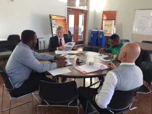 Mayowa Ogundipe, Dr. Joe Hoffman, Raymond Azenadaga, and John Brewer (clockwise from left) discuss the progress of SERF's development in a weekly meeting.