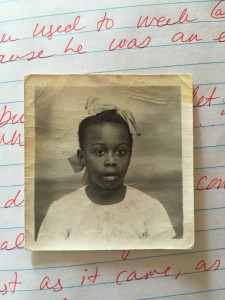 A school photo of a young Joan Charlton rests on the interview notes of ENGL 436 students in Sonia Charlton's home. Photo courtesy of the Charlton family. 