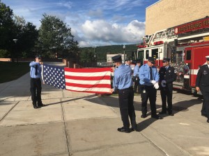 Firefighters fold the U.S. flag at the 9/11 15th Anniversary. (FFD/ Matt McMorran)