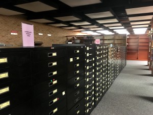 Photo of the cabinets full of microfilmed newspapers located on the second floor of the library (Madie Wilson/TBL)