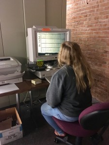 Kayla Hutson, FSU student in the MAT program, views historic New York Times newspapers. (Madie Wilson/ TBL)