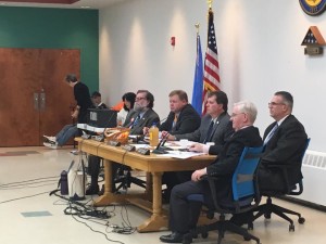 Council members attentively listen to public concern as presented contaminated water rests on their table. (Madie Wilson/ TBL) 