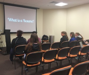 Students listening and taking notes during the presentation. (Madie Wilson/ TBL)