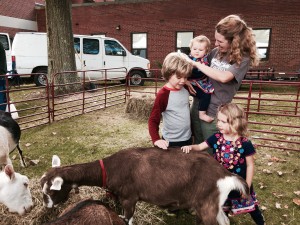 Leanna Koch enjoys petting the goats with her children Billy (left) and Leanna (right). 