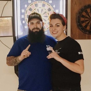 Wood poses with his girlfriend, Alexis at a dart tournament. 