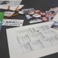 A table at the town hall meeting filled with literature, buttons, and sample ballots.