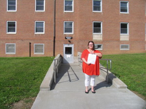 Arnett stands with her letter in front of CAPS to show her committment to an ongoing issue // TBL Gwen Schemm