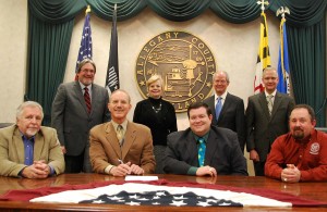 A memorandum of understanding establishing the Allegany County Opportunity Scholarship at Frostburg State University was signed during the Allegany County Commissioners January 16, 2014 public business meeting. Seated from left are former Commissioner Valentine, former FSU President Dr. Jonathan C. Gibralter, and former Commissioner McKay and current Commissioner Brodie. Standing from left are FSU Interim Provost Dr. William P. Childs, FSU Foundation Director of Finance and Administration Alicia White, FSU Vice President of Student and Educational Services Dr. Thomas L. Bowling and Allegany County Administrator David A. Eberly.